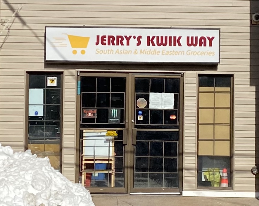 A store front with a yellow-on-white sign. I bet it looked great on the computer screen.